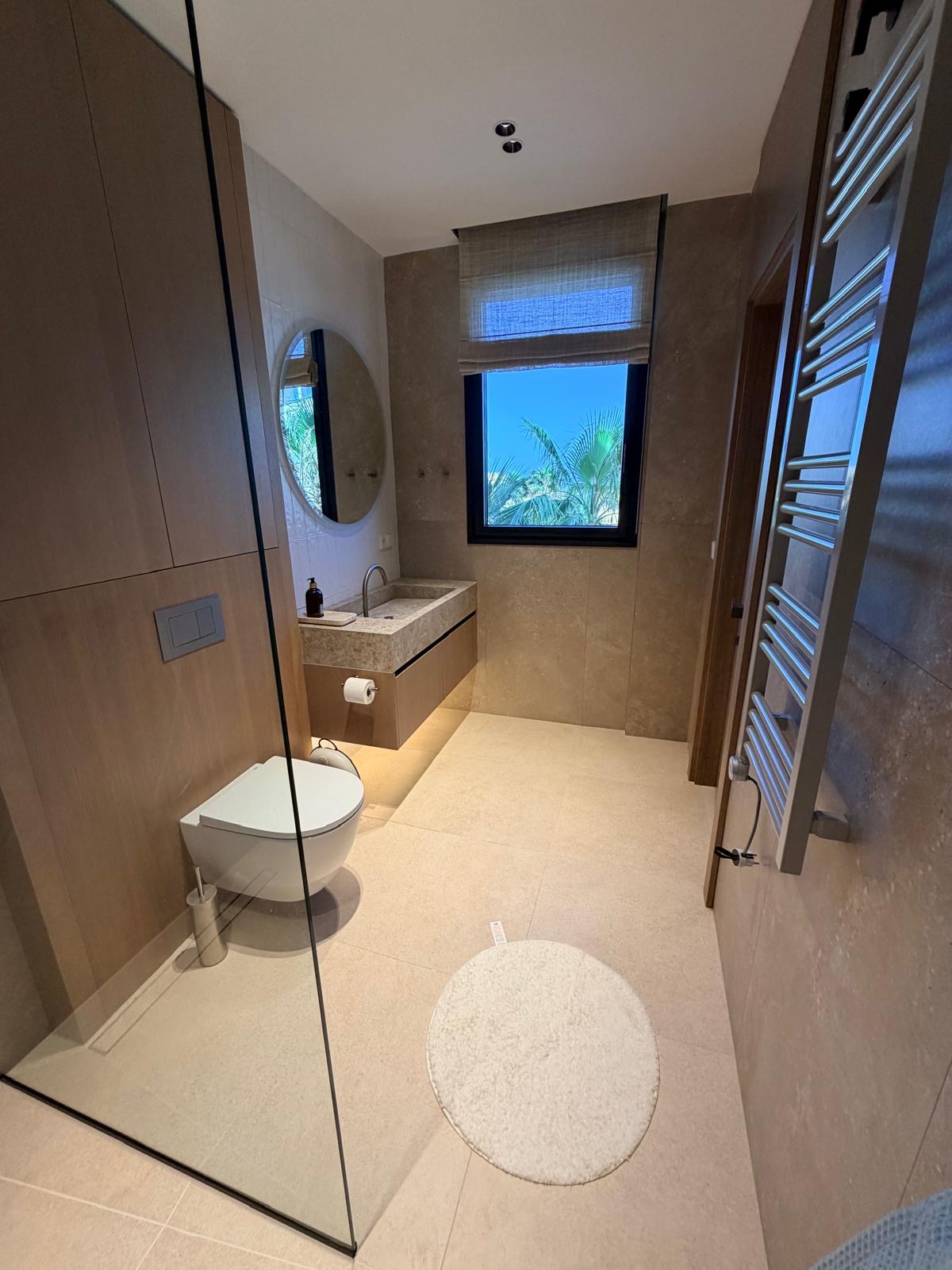 Full-height stone bathroom in a delivered residence